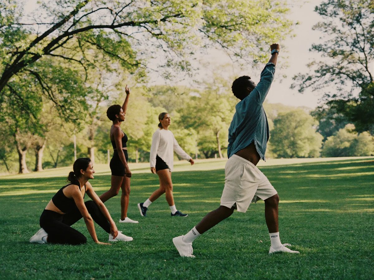 A diverse group of adults enjoying movement together outdoors